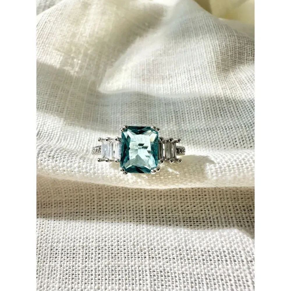 Light blue elongated radiant cut ring